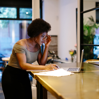 African American women at a hotel front desk