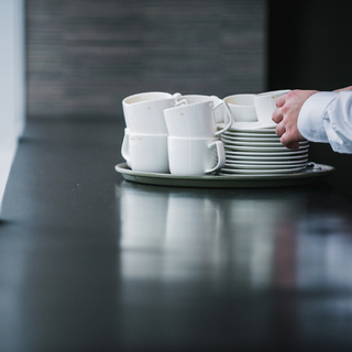 dishes on a table like they're being collected by a server