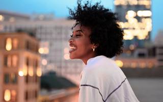 person on a rooftop looking over a cityscape