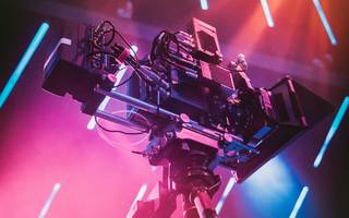 video camera surrounded by neon lights