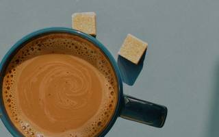 overhead view of a coffee with two sugar cubes