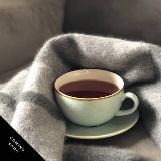 coffee cup with a towel wrapped around it