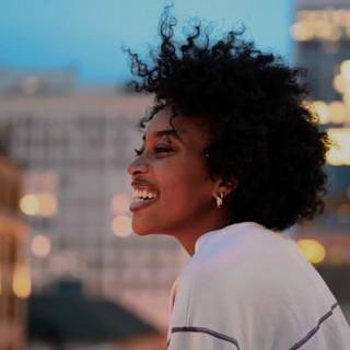 Woman on rooftop overlooking city