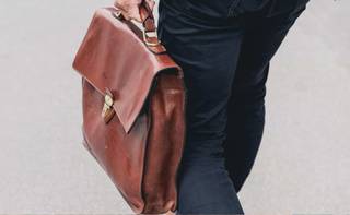 Man holding leather briefcase